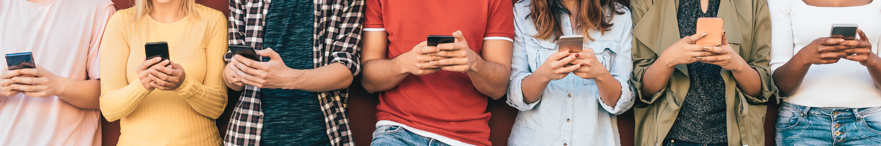 group of people checking their mobile phones